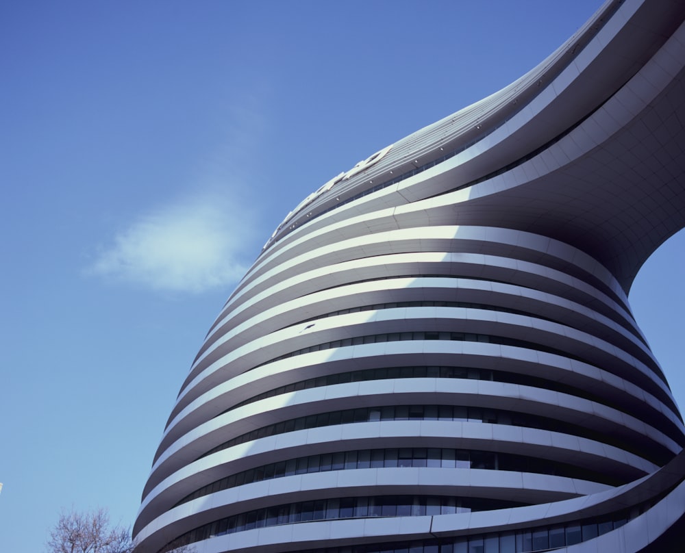 a curved building with a sky background