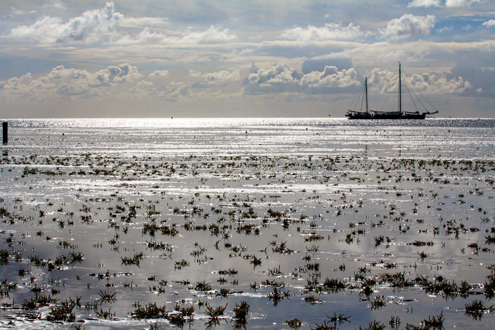 a boat floating on top of a large body of water