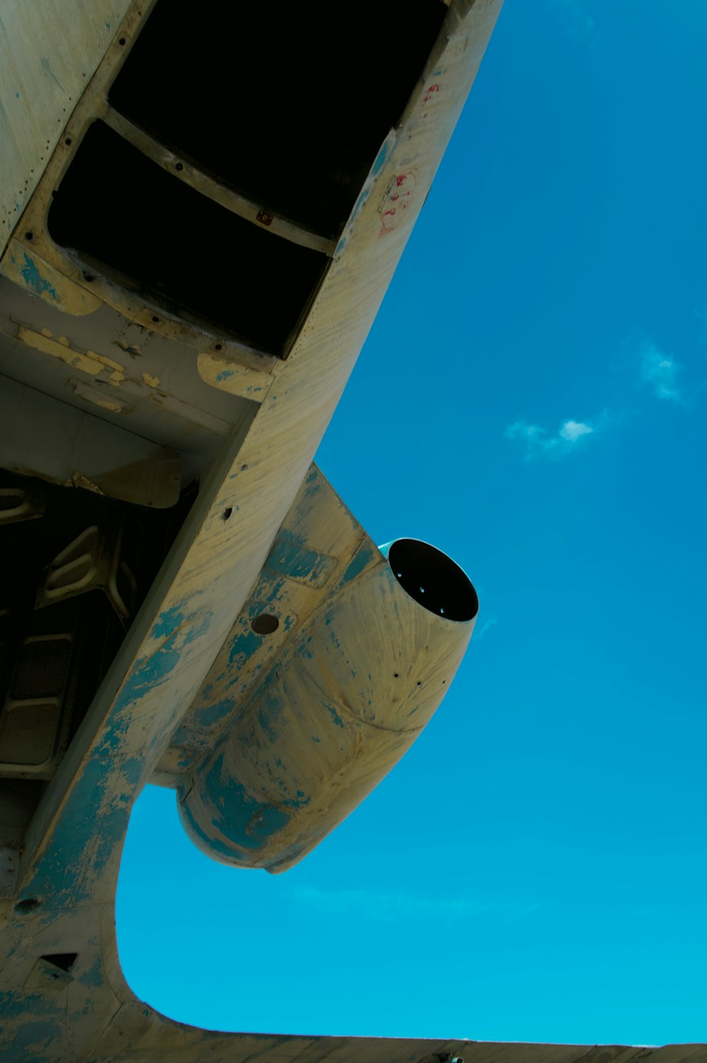 the underside of an airplane with a blue sky in the background