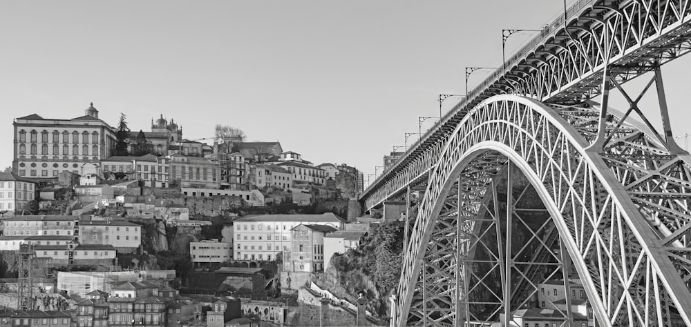 a black and white photo of a bridge and a city