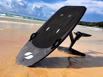 a surfboard sitting on top of a sandy beach