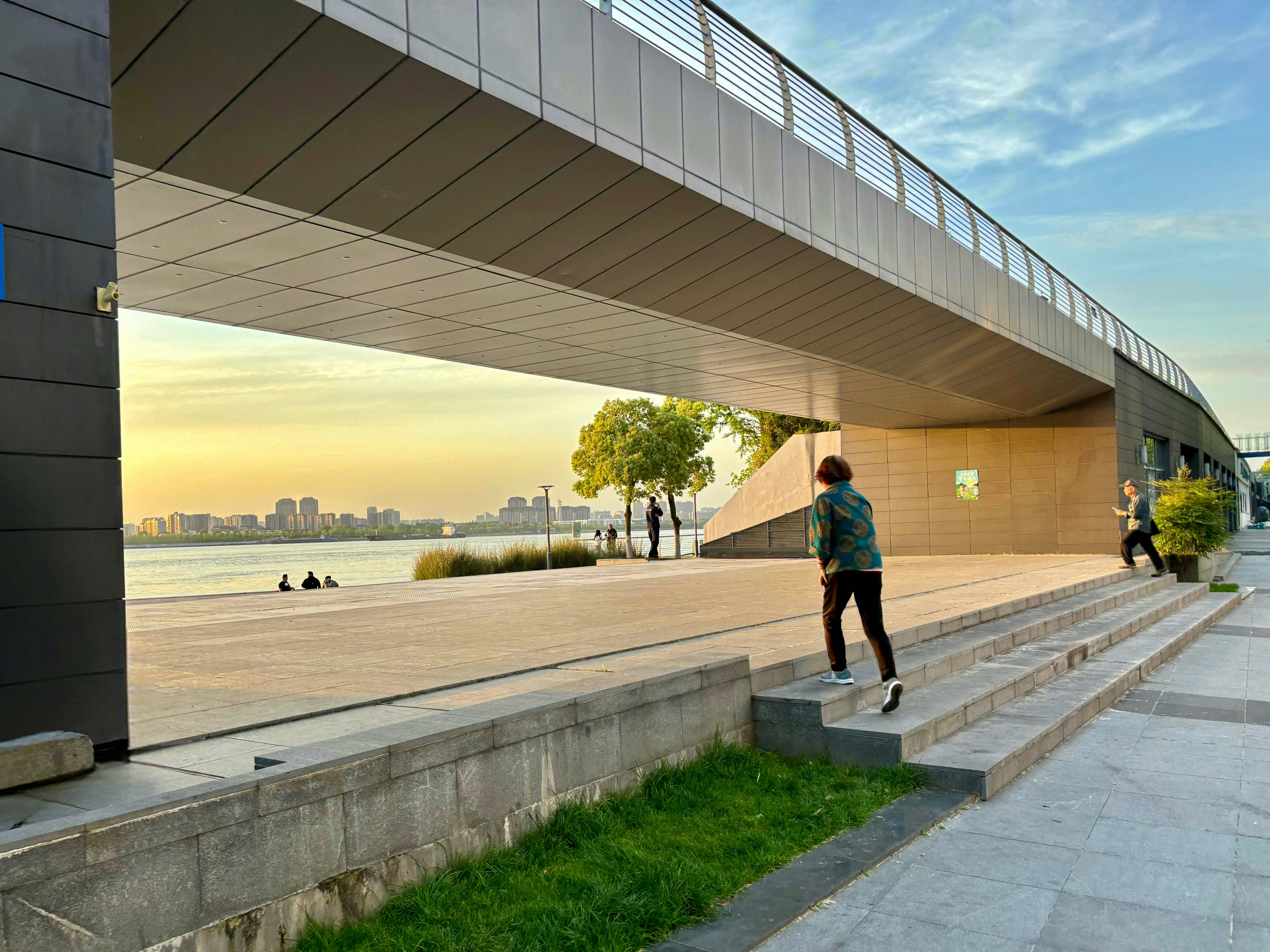 a man is walking down some steps by the water, Nanjing Zhongshan Port