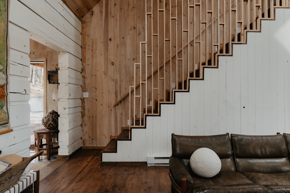 a living room with a couch and a stair case