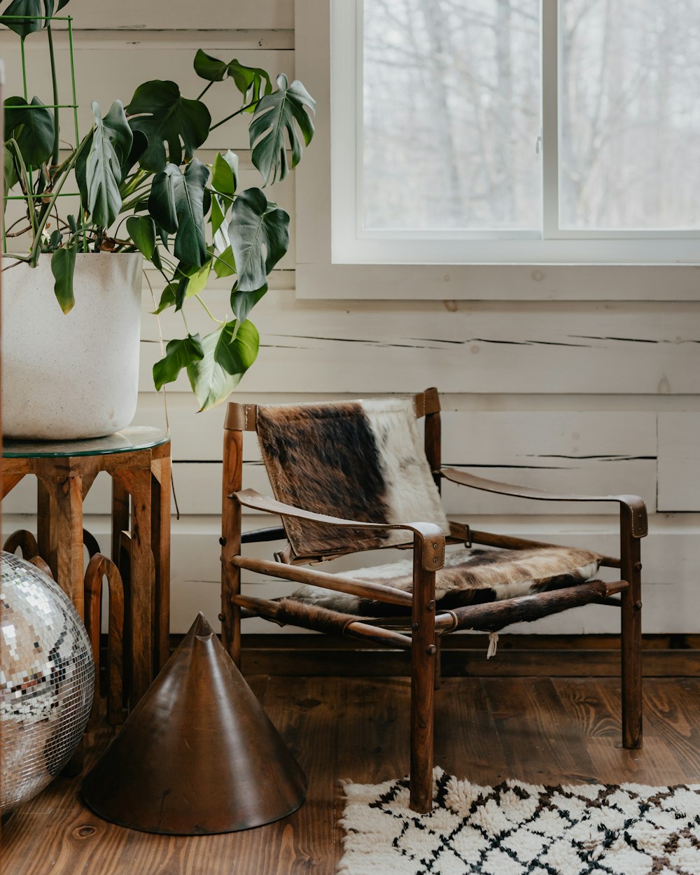 a chair and a potted plant in a room