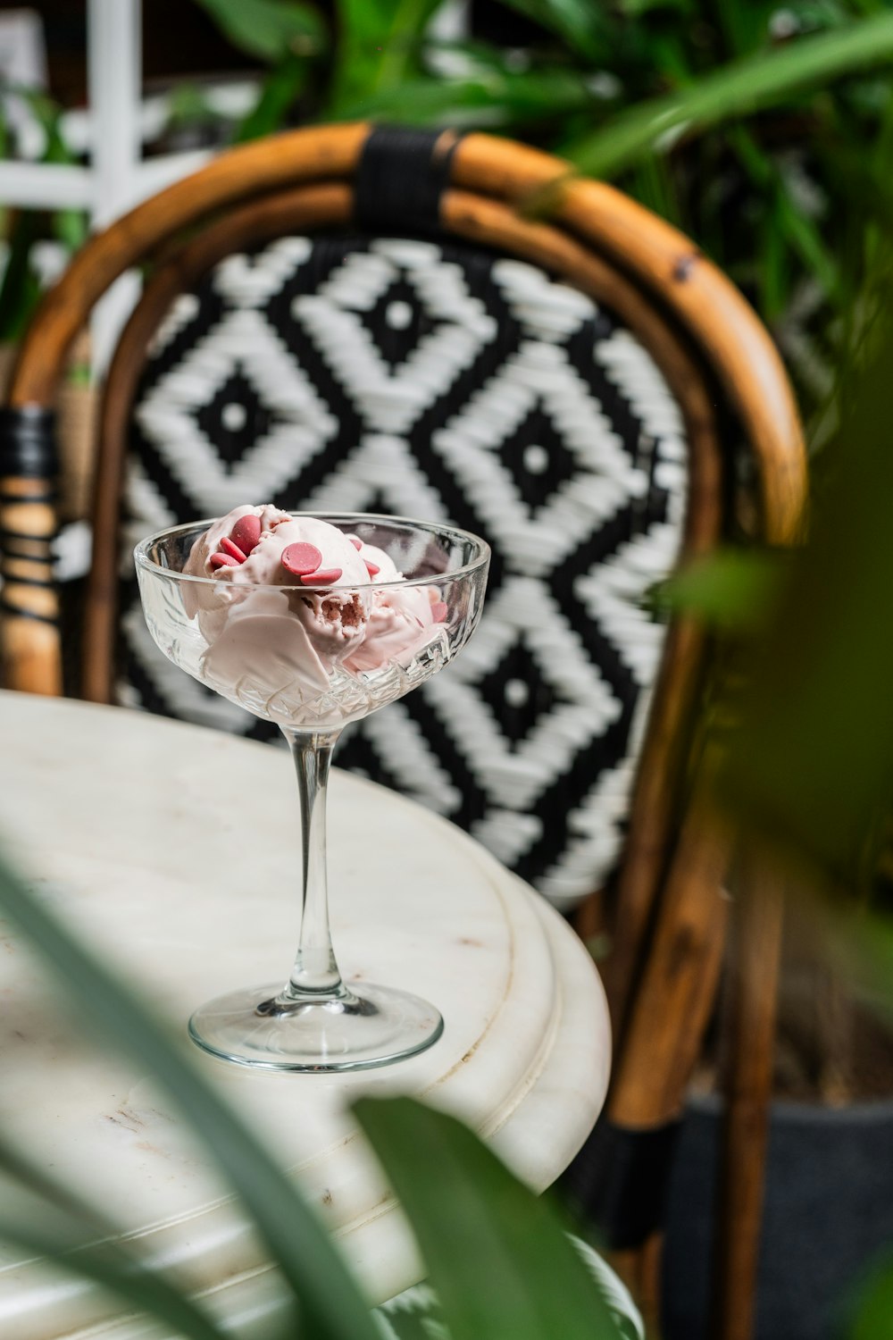 a glass of ice cream sitting on top of a table