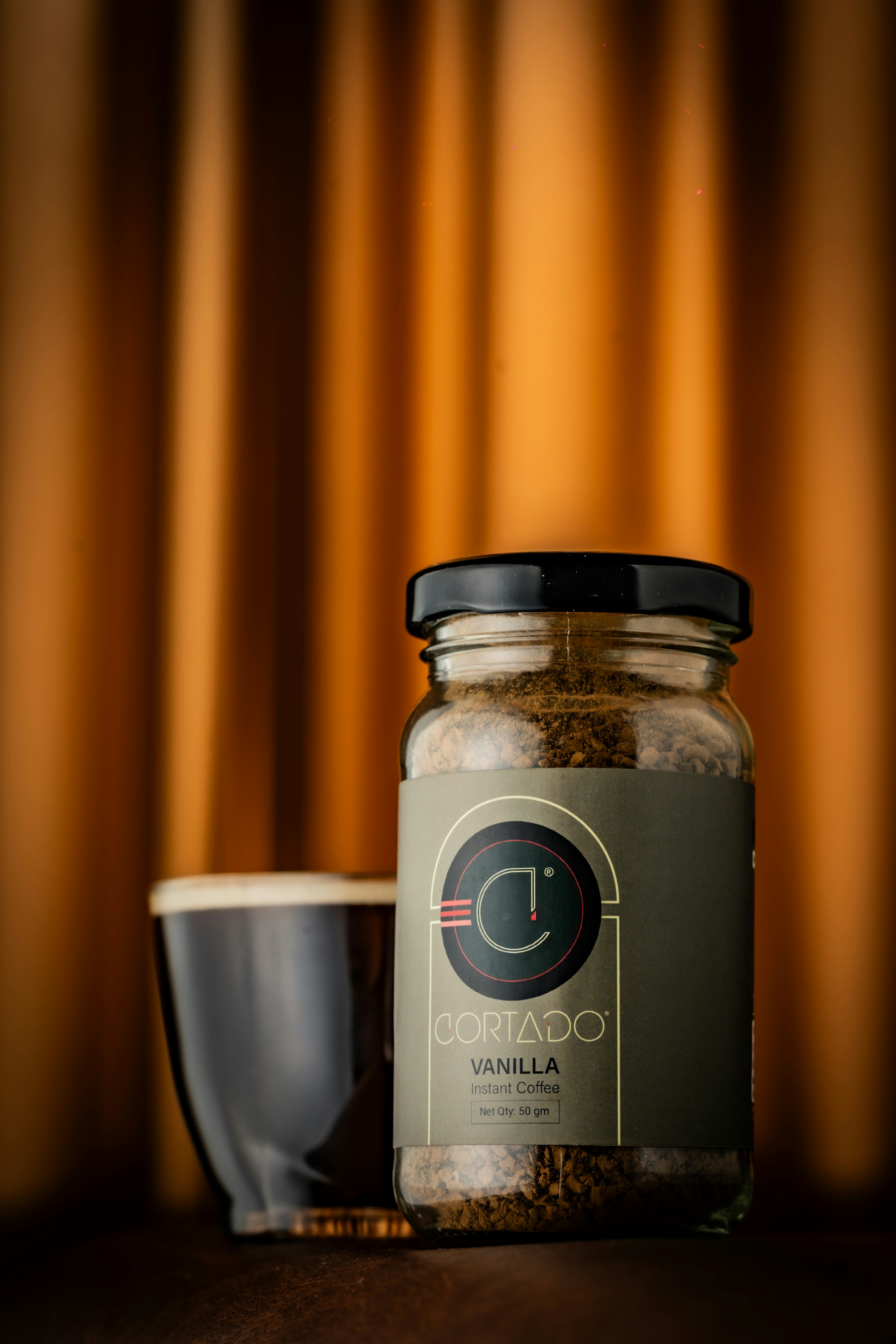 a jar of spices next to a cup of coffee