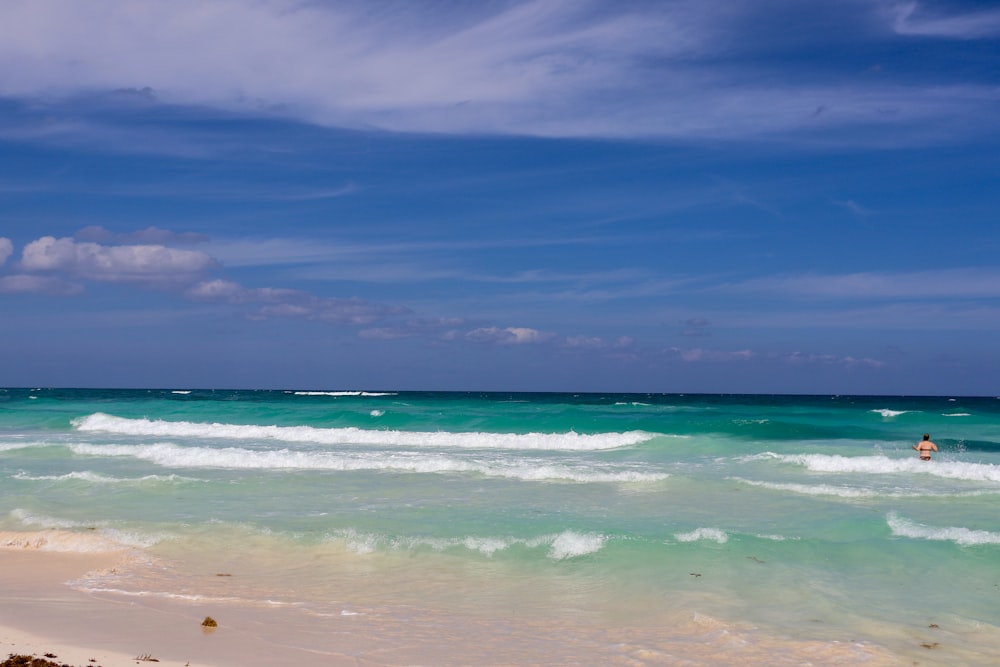 a person standing on a surfboard in the ocean