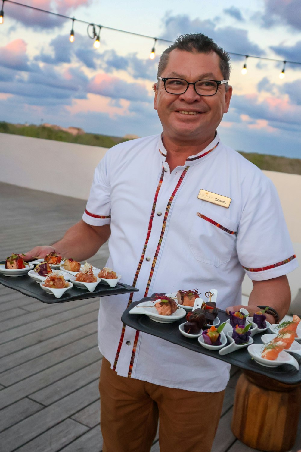 a man is holding a tray of food