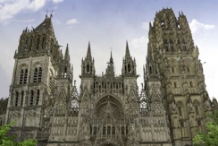 a large cathedral with a clock on the front of it