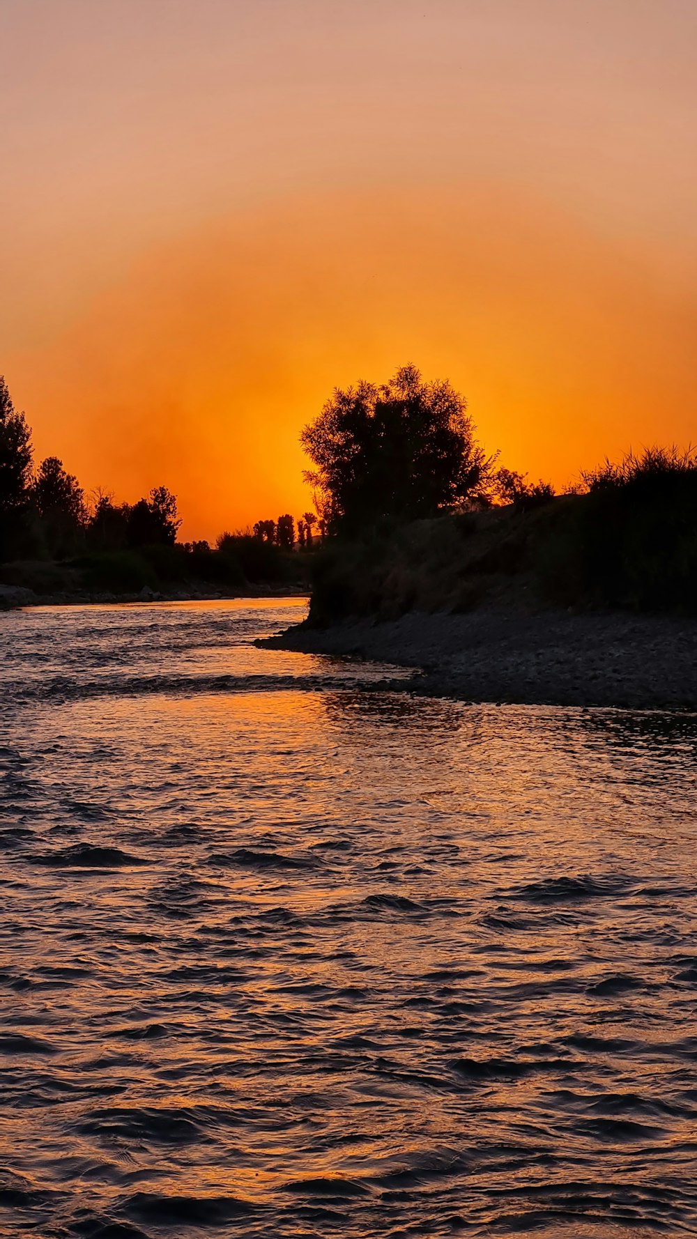 the sun is setting over a body of water