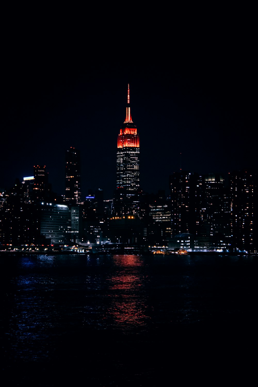 a view of a city at night from the water