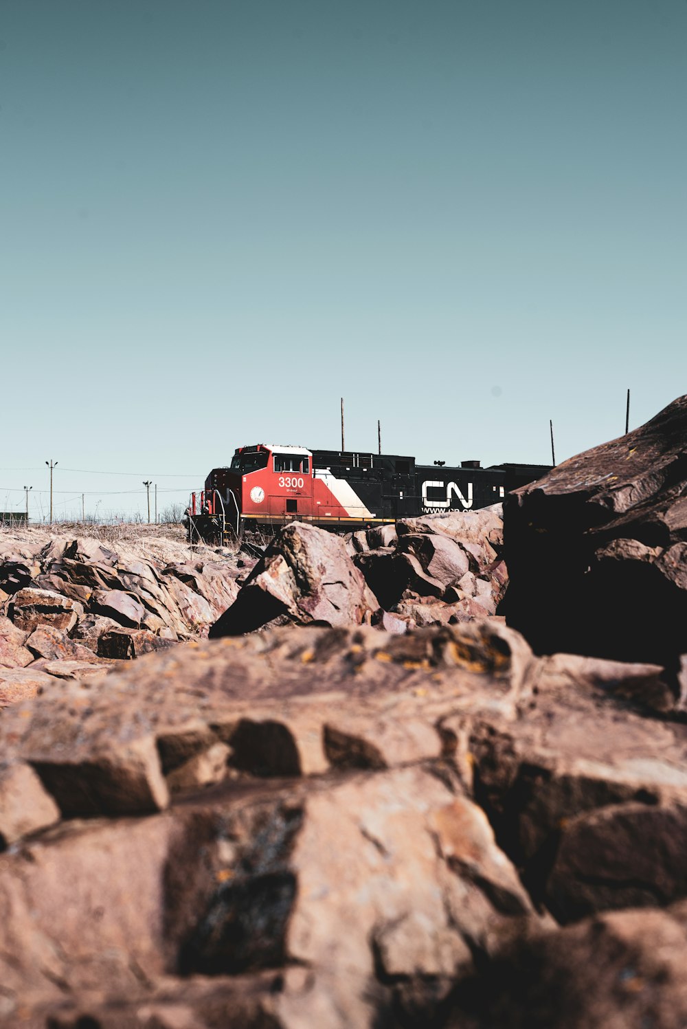 a red and white train traveling down train tracks