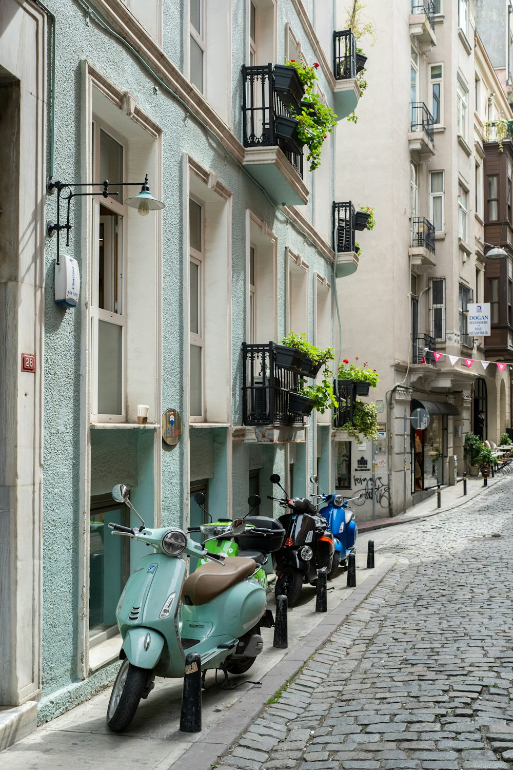 a row of scooters parked on the side of a street