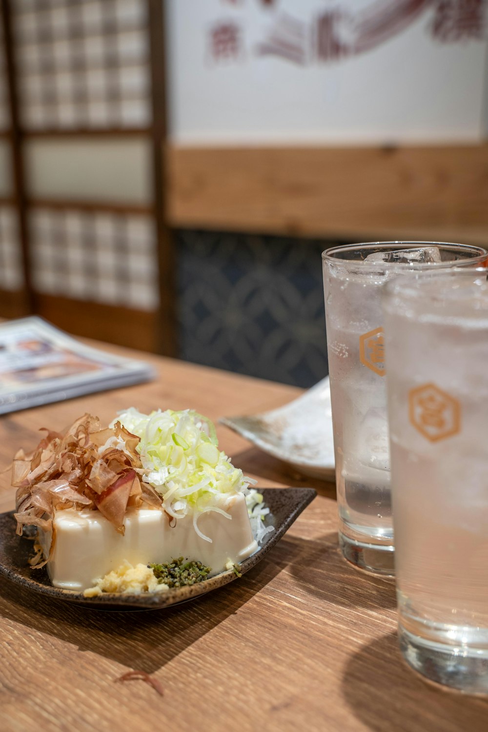 a plate of food and a glass of water on a table