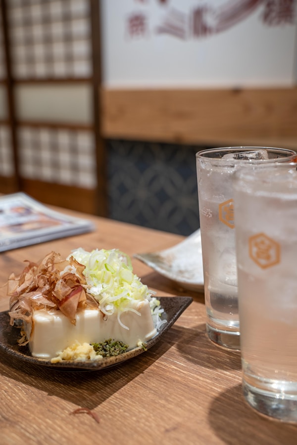 A plate of food and a glass of water on a table