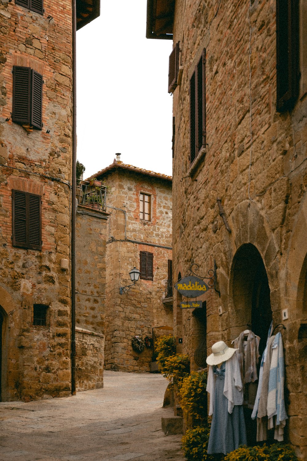 an alley way with clothes hanging out to dry