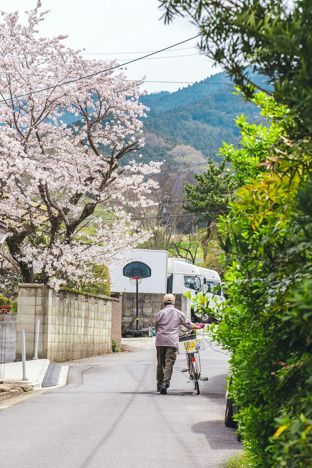 a person walking down a street with a bike