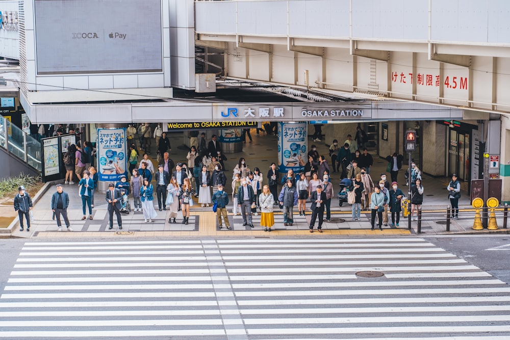 a group of people standing in front of a building