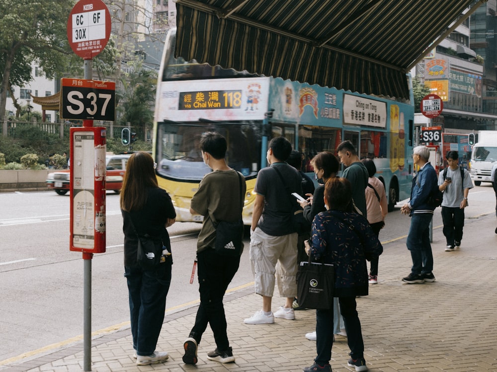 a group of people waiting at a bus stop