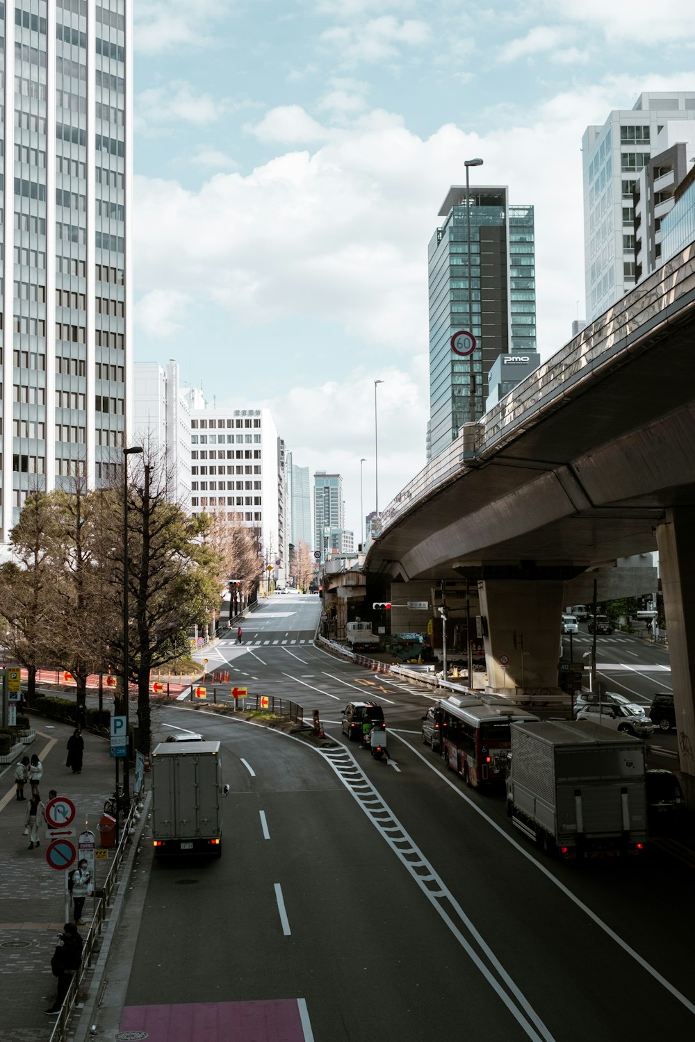 a city street with a bridge over it