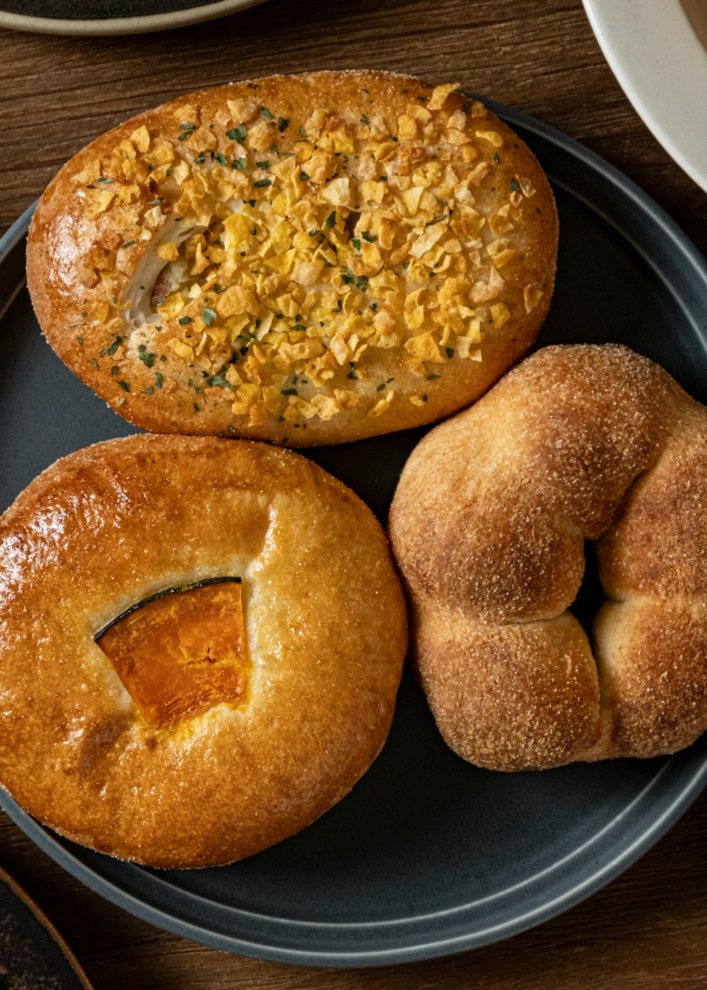 a blue plate topped with three different types of bread