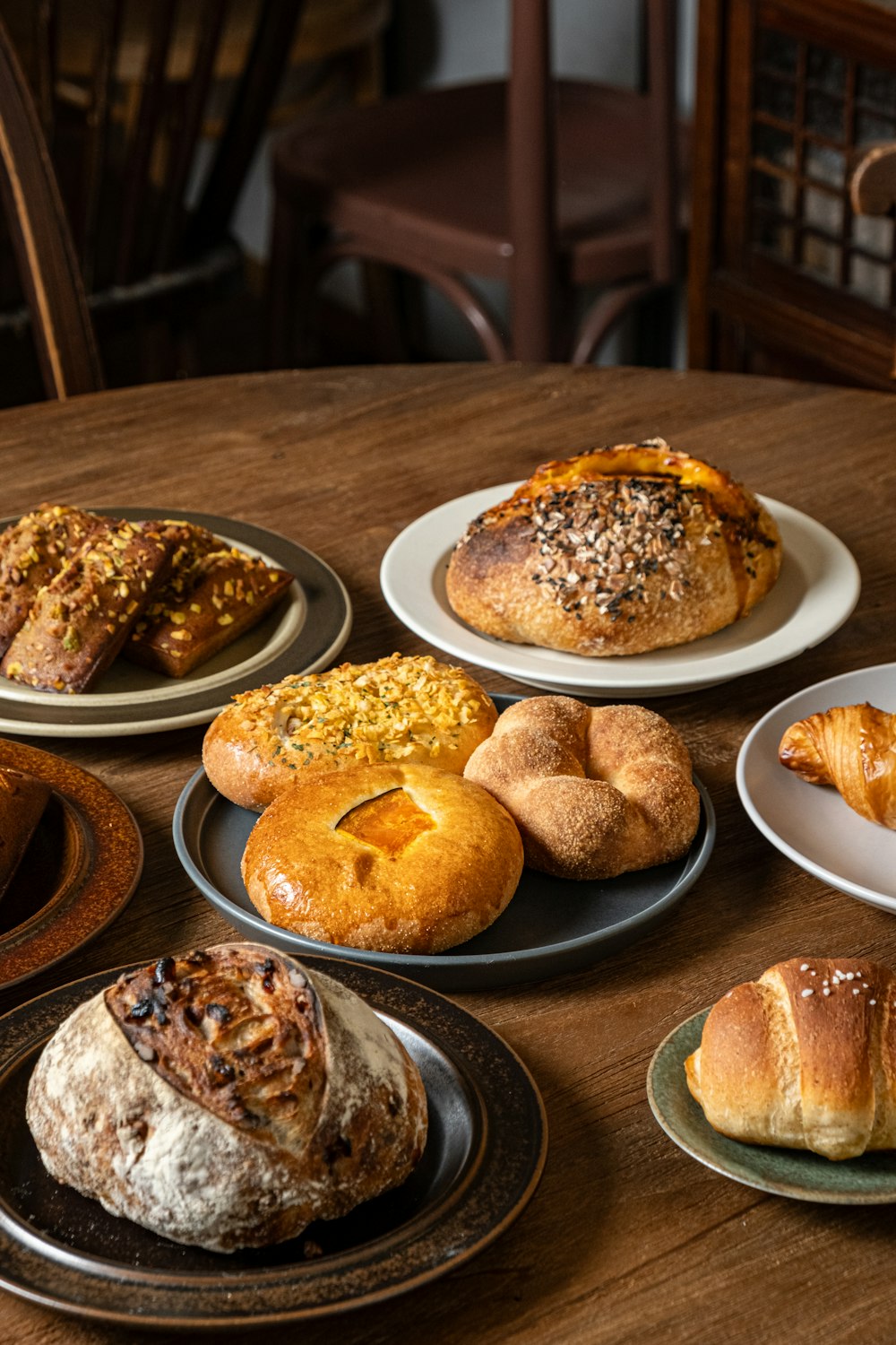 a wooden table topped with plates of food