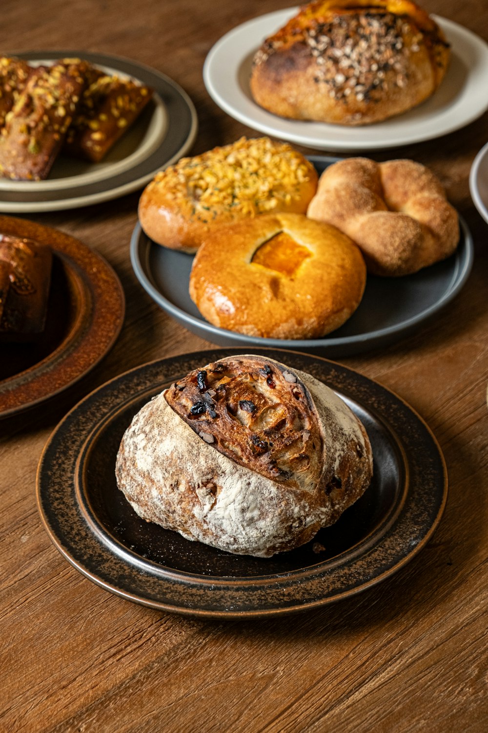 a wooden table topped with plates filled with pastries