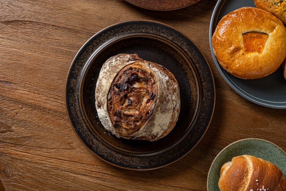 a wooden table topped with plates of food