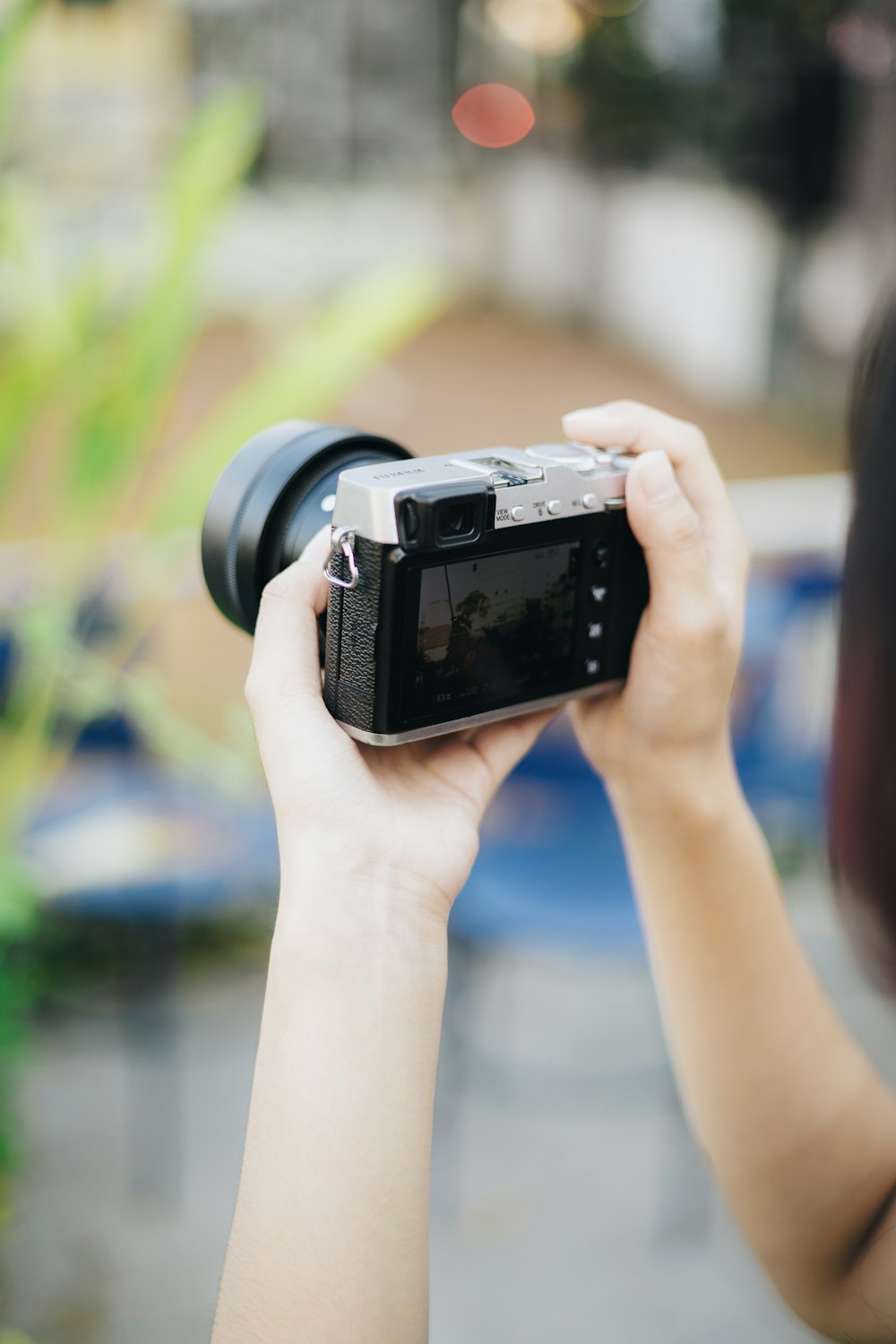 a woman holding a camera up to take a picture