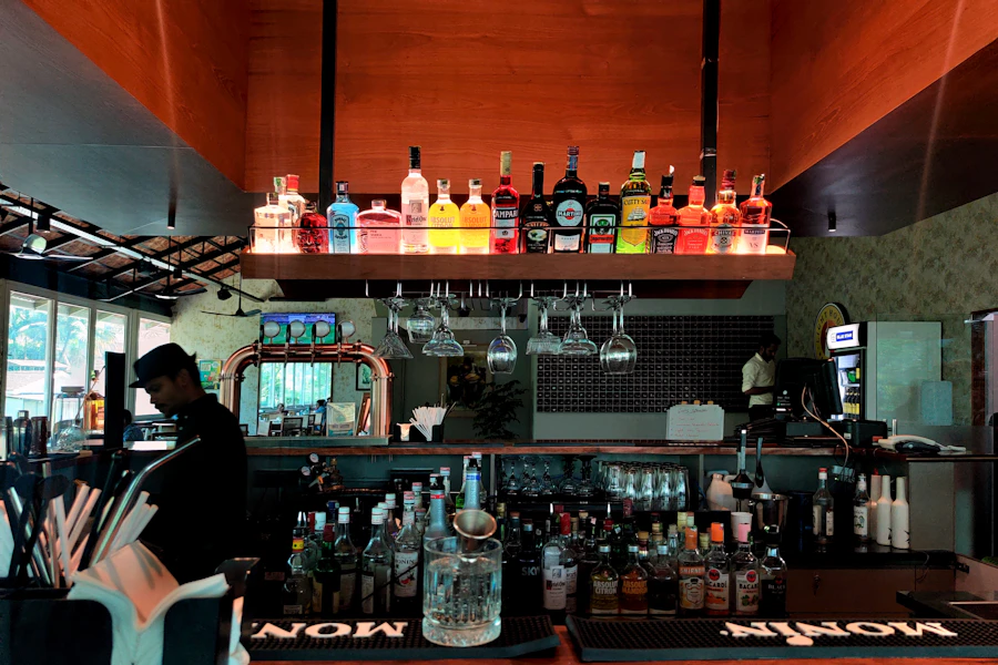 Back bar lined with bottles, low light