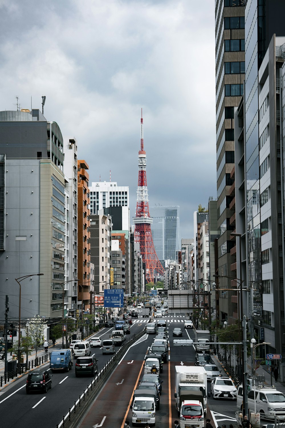 a city street filled with lots of traffic next to tall buildings