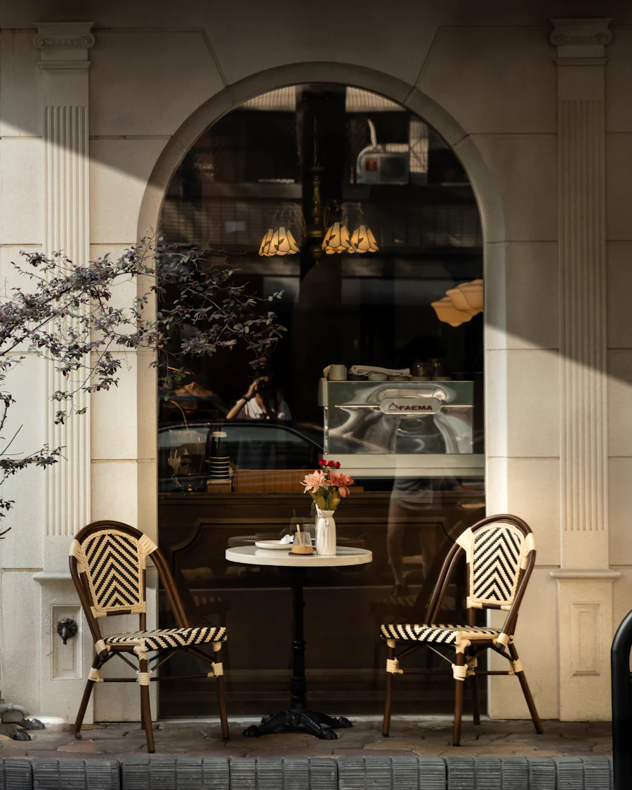 Two chairs facing each other beside a bright window in a quiet room.