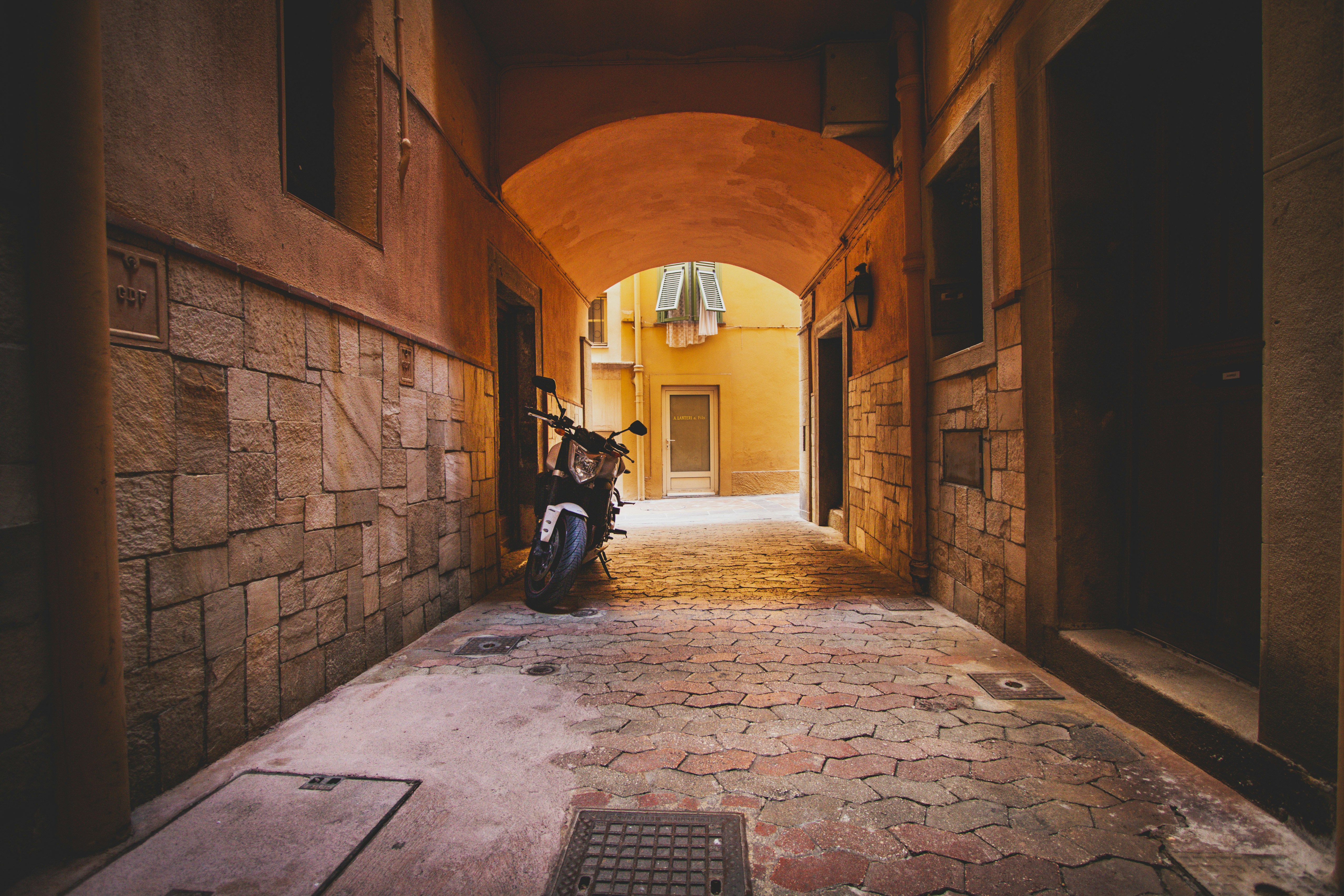a person sitting on a bench in an alley