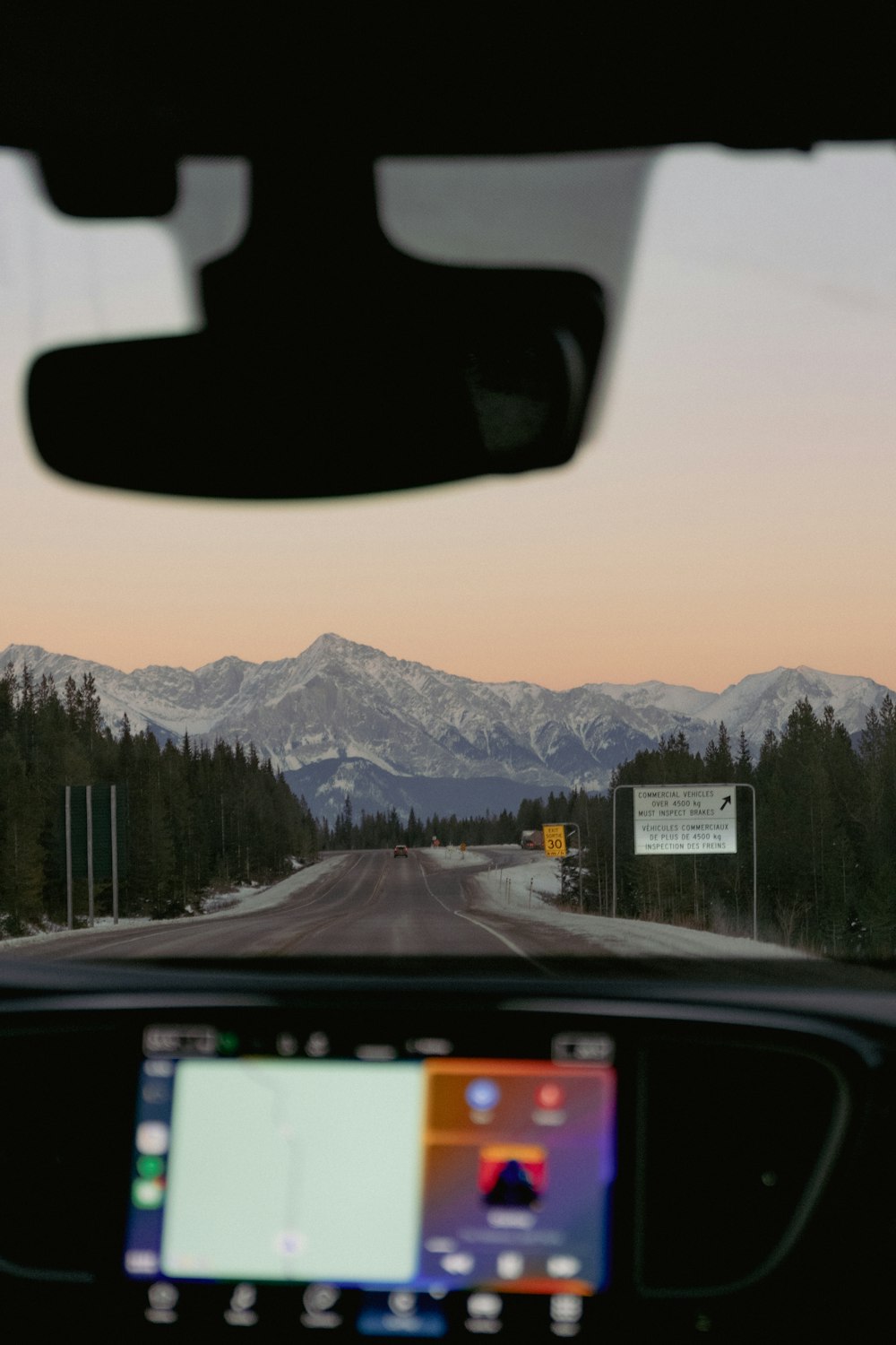 a view of a mountain range from inside a car