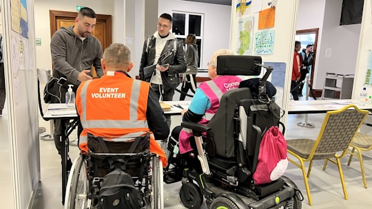 a group of people in wheelchairs in a room