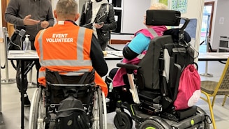 a group of people in wheelchairs in a room
