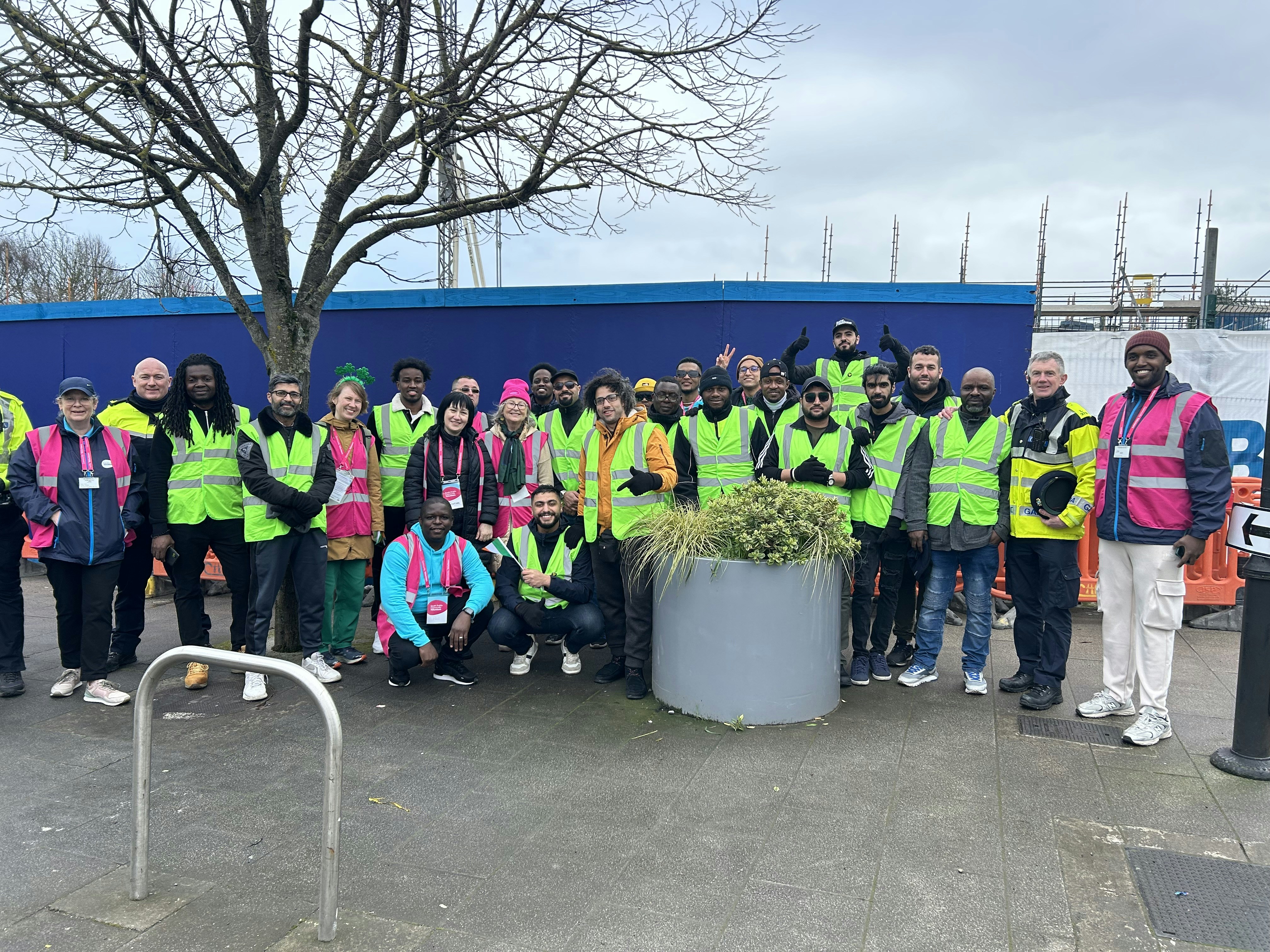 a group of people in safety vests posing for a picture