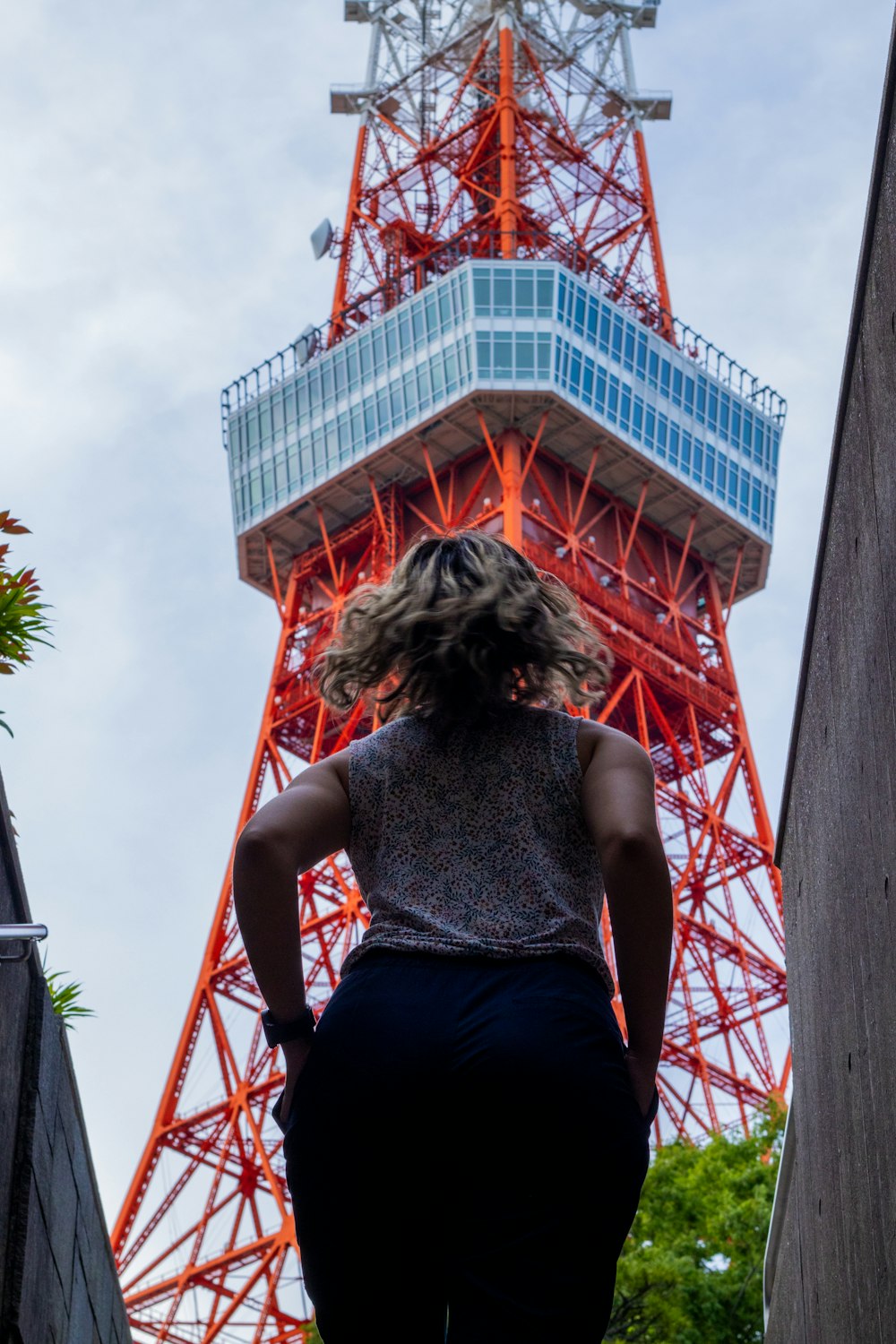 a woman walking up the stairs to the top of a tower
