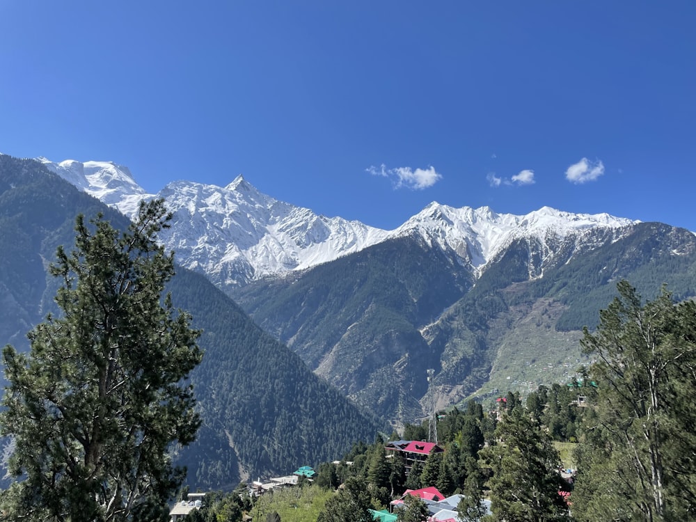 a view of a mountain range with houses in the foreground