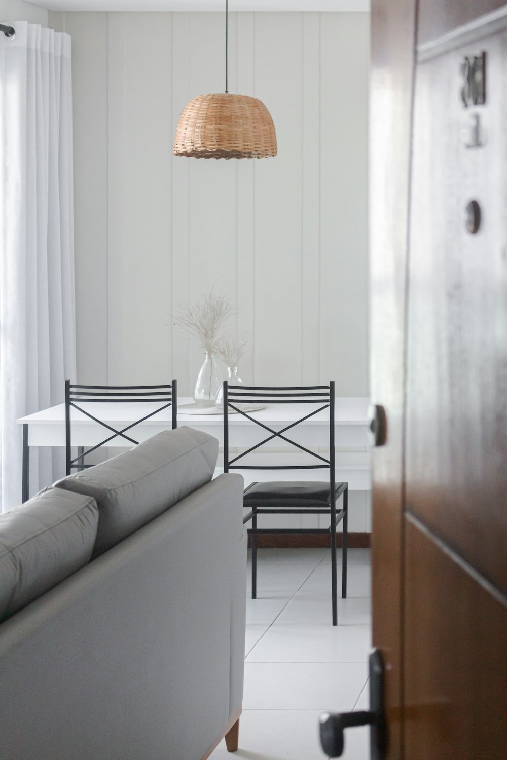 a living room filled with furniture and a lamp