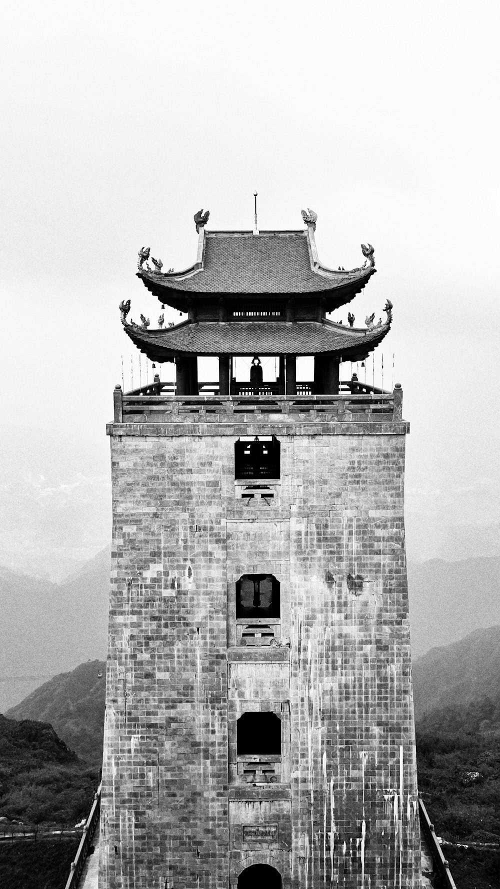 a black and white photo of a tall tower