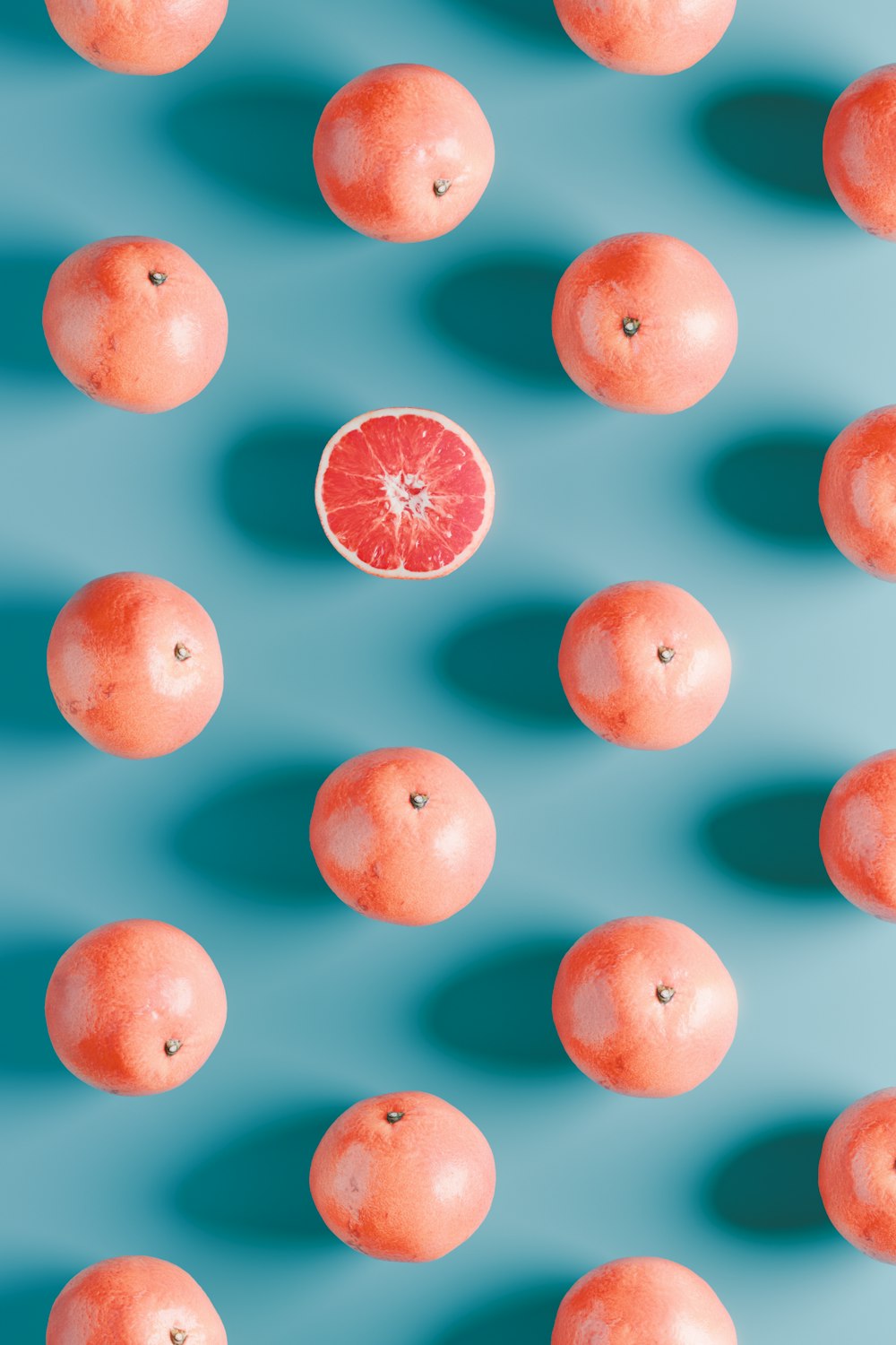 a group of oranges sitting on top of a blue surface