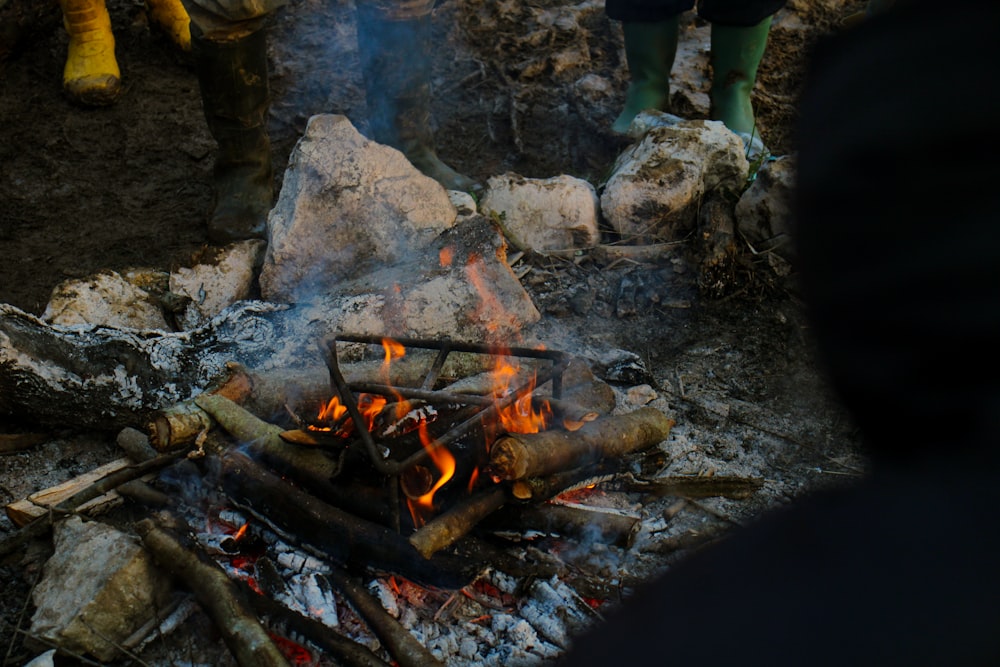 a campfire with a person standing next to it