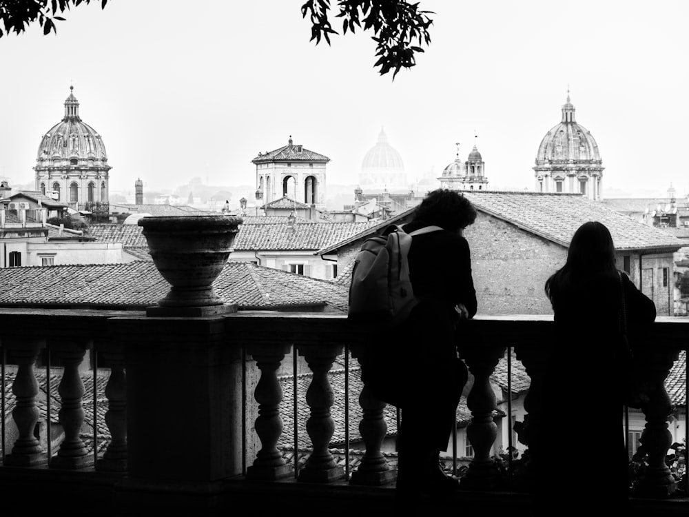 a couple of people standing on top of a balcony