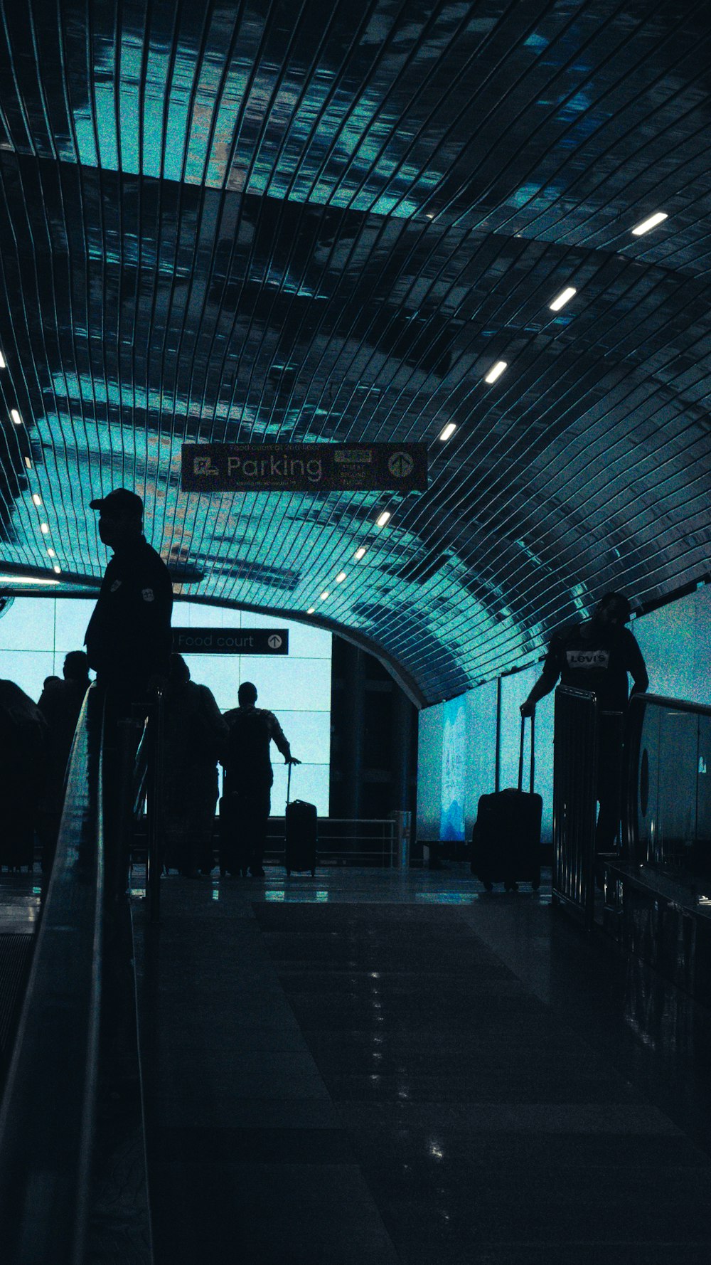 a group of people walking through an airport