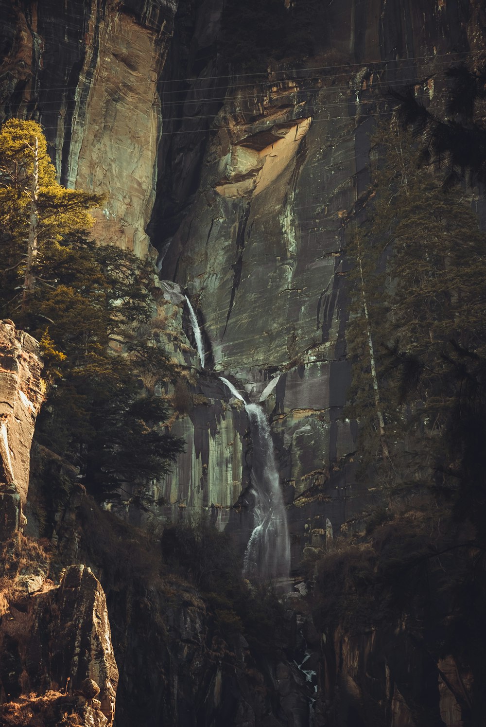 a waterfall in the middle of a forest