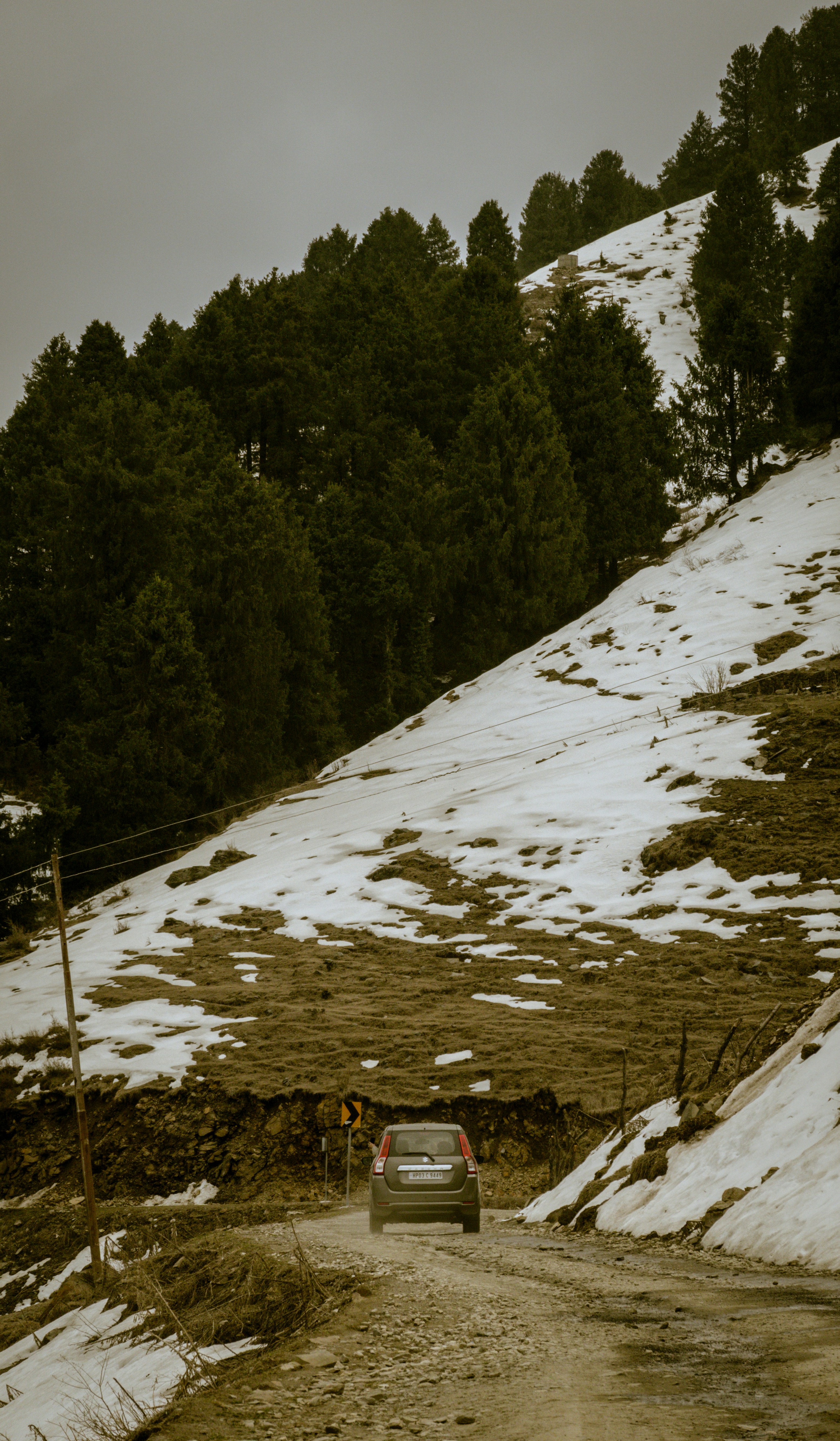 A car driving down a snow covered road photo – Free Wallpaper for ...