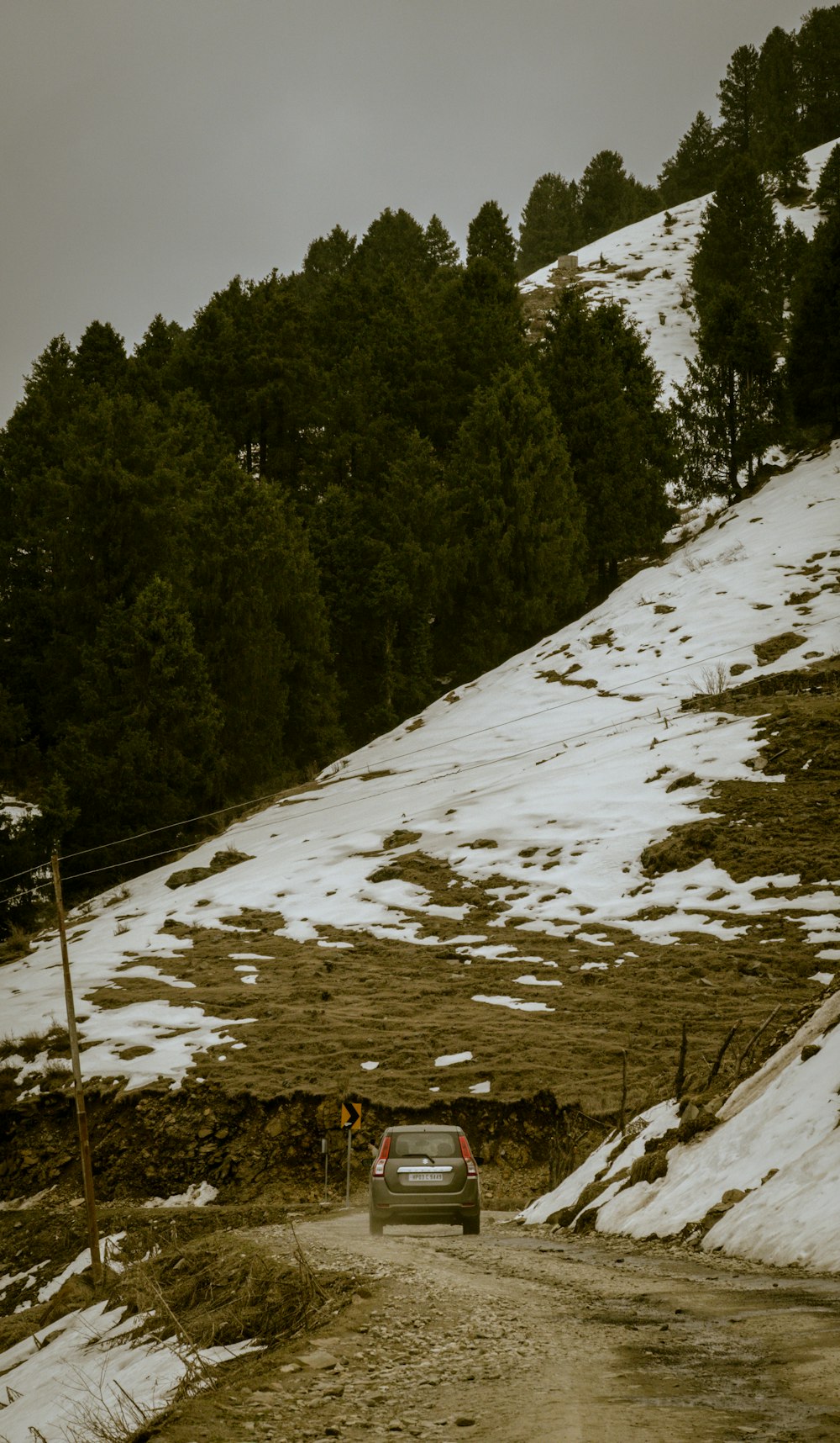 a car driving down a snow covered road