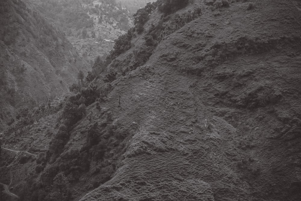 a black and white photo of a mountain side