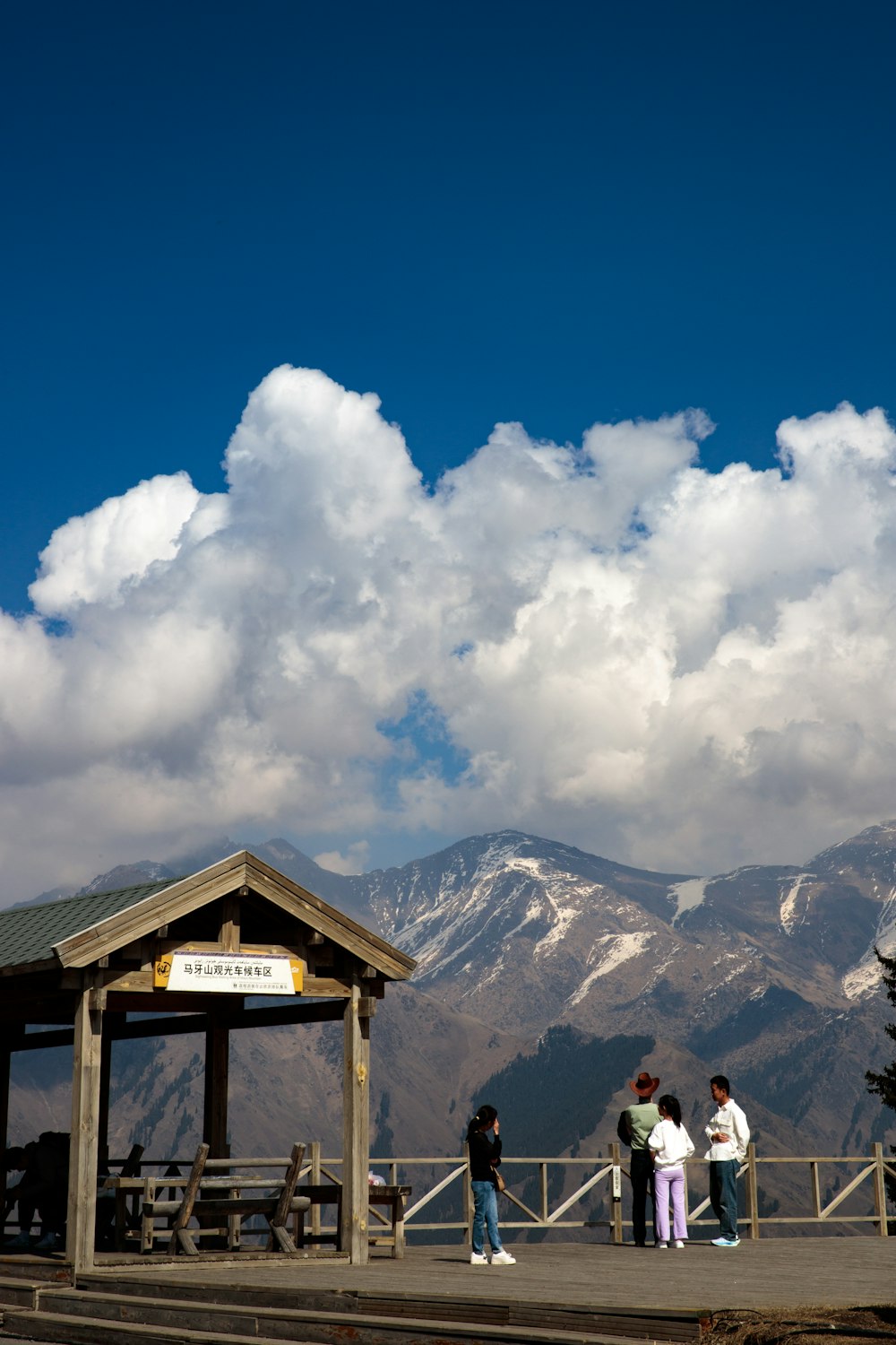 a group of people standing on top of a wooden platform